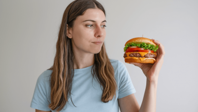 Дівчина задумливо дивиться на бургер